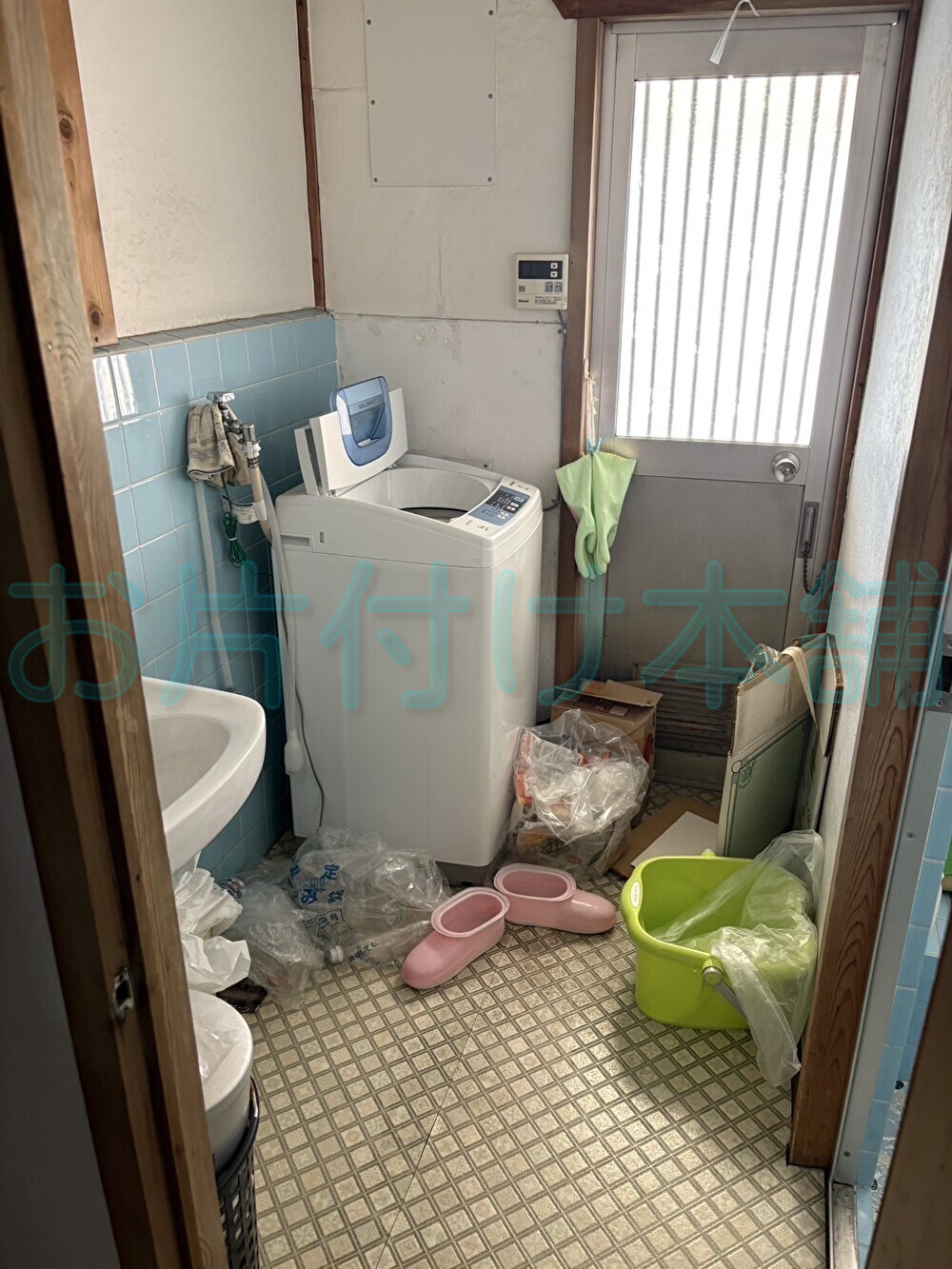 お片付け本舗による大津市のお片付け事例。洗濯機や洗面用品が置かれた片付け前の洗面所。